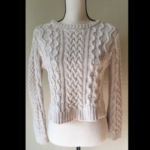 Knitted cream colored crop sweater.
